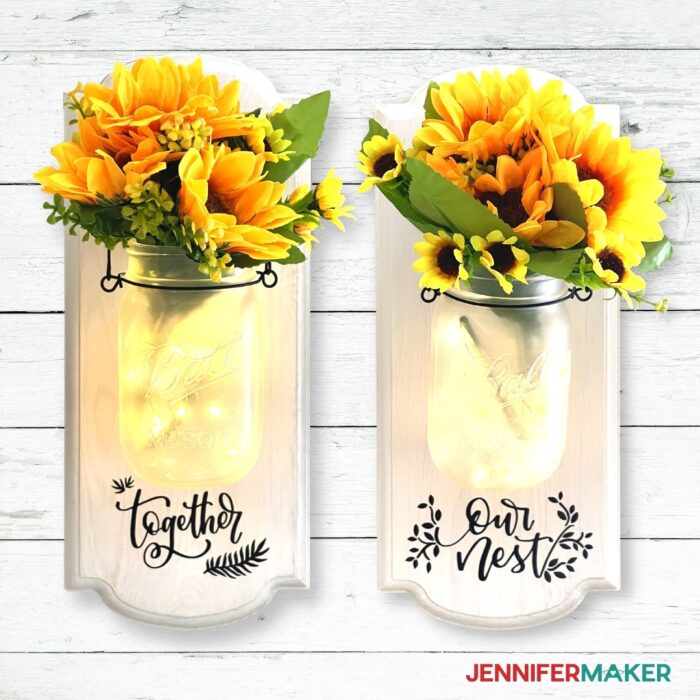DIY mason jar wall decor with some fairy lights and flowers inside of them