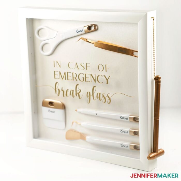 DIY Shadow Box with gold Cricut tools inside and vinyl decal on glass that says, "in case of emergency, break glass"