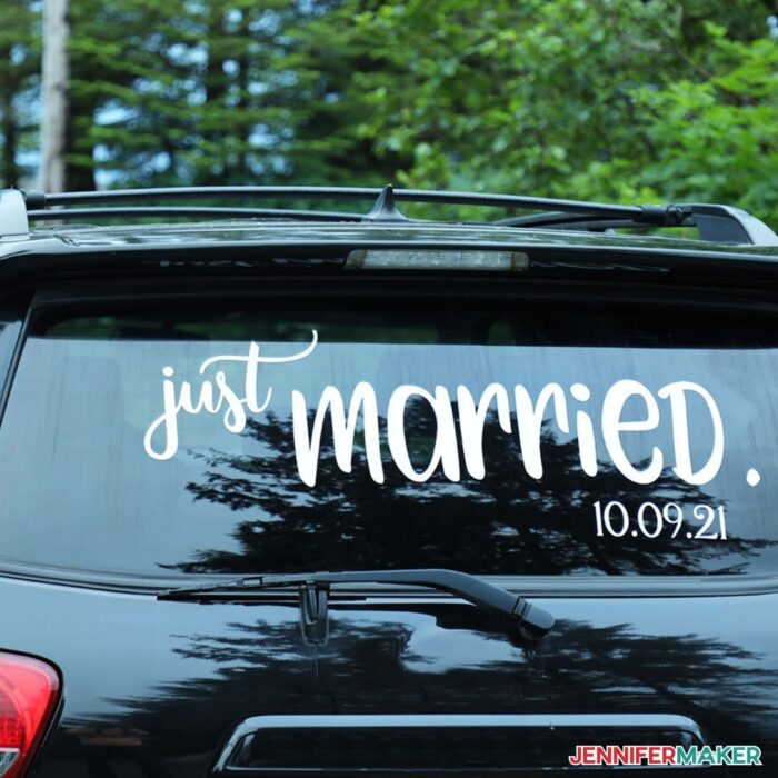 Vinyl Letter Decals with the words "just marries" on the rear window of a black car