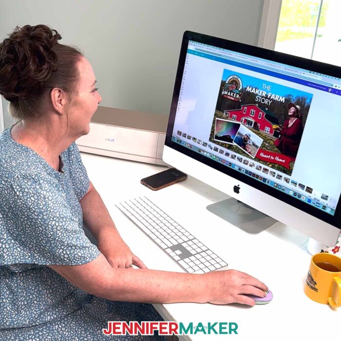 Jennifer Maker sits at her computer desk and works on her DIY Photo Book she's creating with Canva