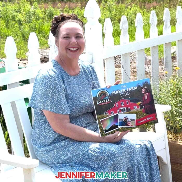 Jennifer Maker sits in her garden at Maker Farm and holds her DIY Photo Book she created with Canva