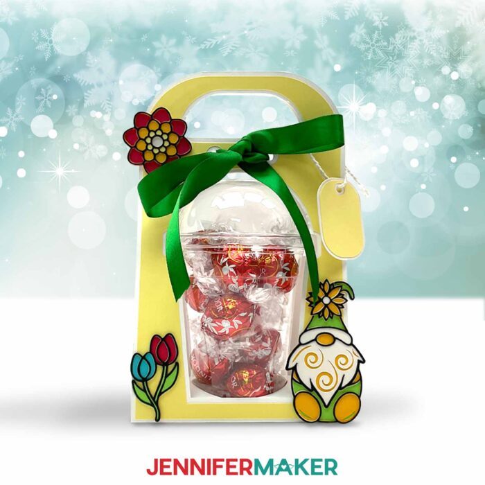 Make a dome cup holder with JenniferMaker's tutorial! A holiday-themed domed cup holder sits against a snowy background.