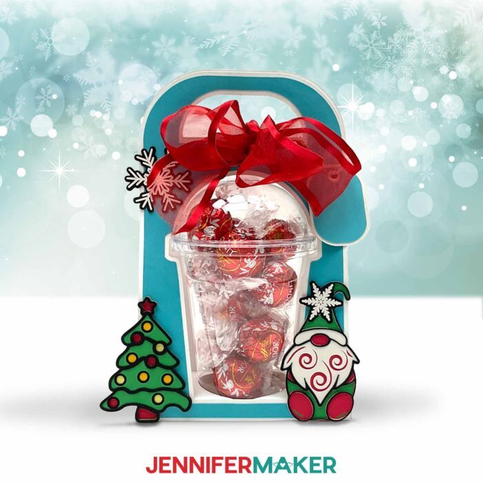 Make a dome cup holder with JenniferMaker's tutorial! A holiday-themed domed cup holder sits against a snowy background.