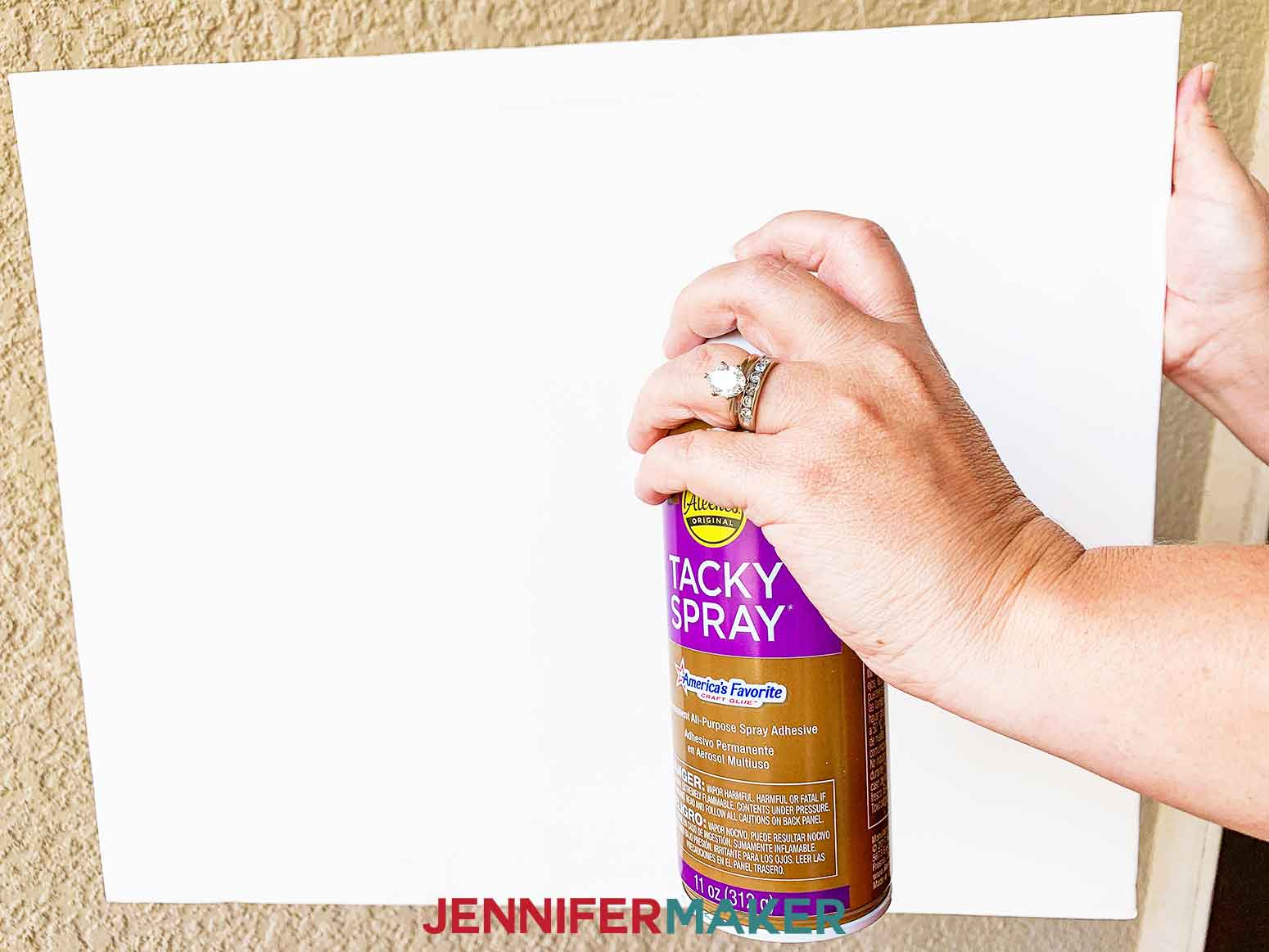 Spraying Tacky Spray on 16" x 20" canvas to prep for applying Easy Paper Heart Tree by JenniferMaker