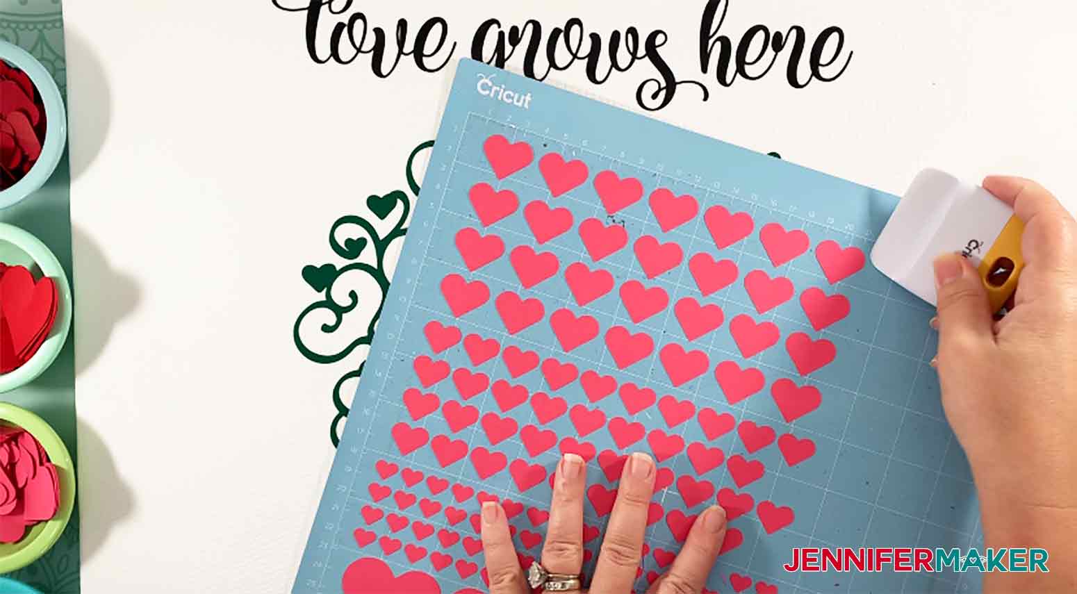 Using scraper to get paper hearts off Cricut mat for Easy Paper Heart Project by JenniferMaker