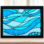 Faux stained glass window with blue waves made with Sharpie markers and vinyl lead lines on a Cricut