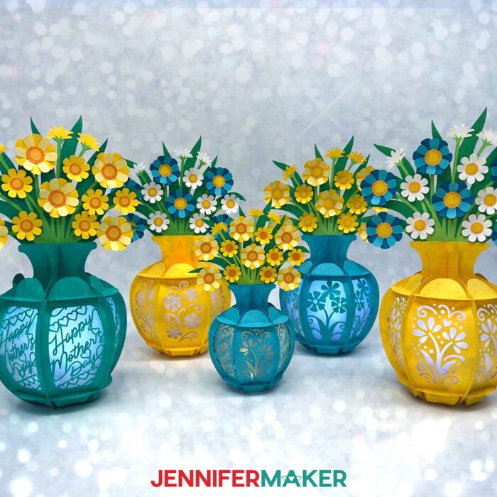 An arrangement of five flower bouquet lanterns with different flowers and different sizes by JenniferMaker.