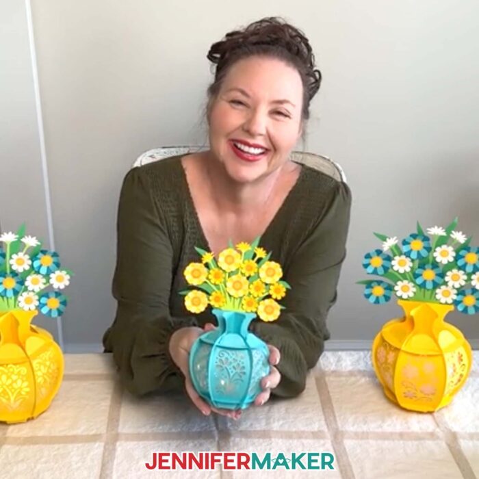 JenniferMaker holding a smaller version of her Flower Bouquet Lantern made using a Cricut Joy.