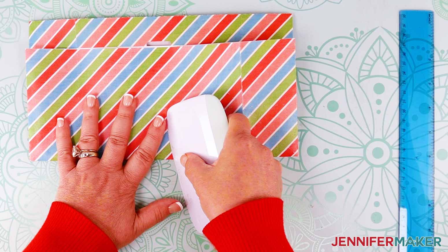 Use a scraper to crease the lower lines of the gift bag.