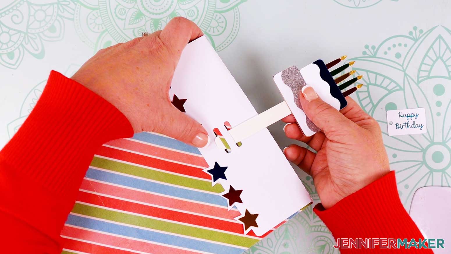 Insert the pick through the slots in the top-fold of the gift bag.