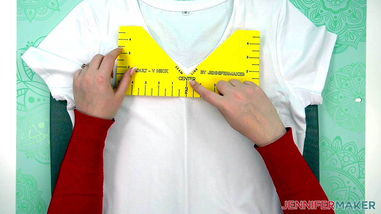 Place the t shirt guide on the center crease on the shirt and at the bottom edge of the neck seam.