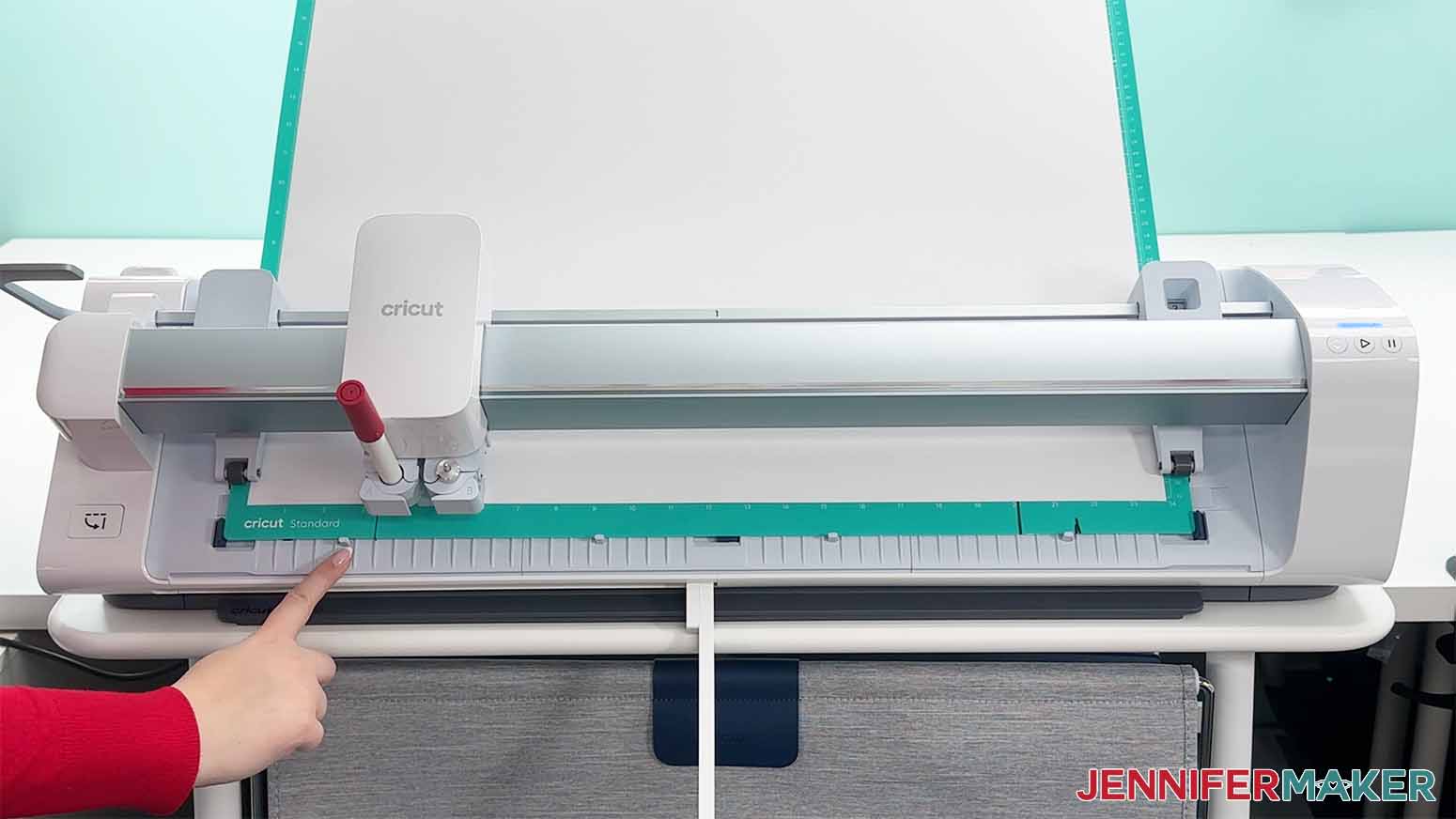 How to Draw with Cricut. An image of the mat being fed into the Cricut Venture for the bigger heights poster.