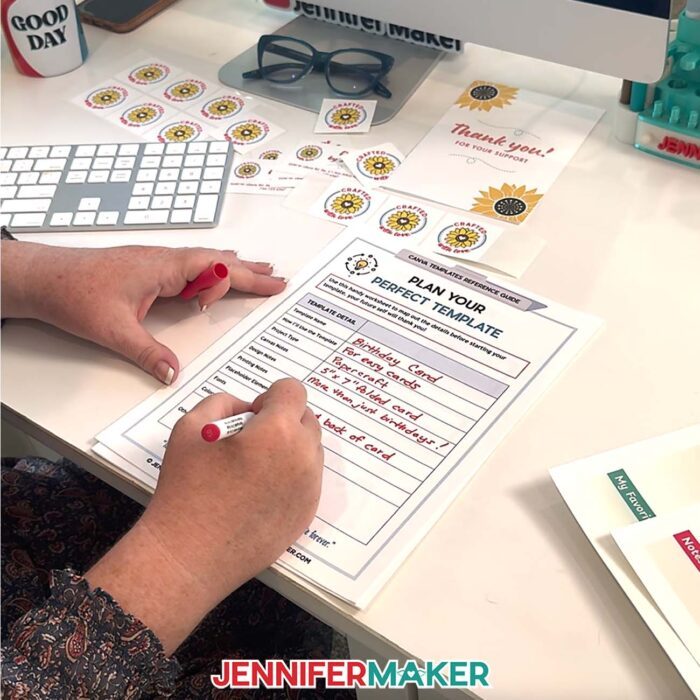 Jennifer Maker fills out a "Plan Your Perfect Template" worksheet at her computer desk. Learn How To Make Canva Templates with the free tutorial
