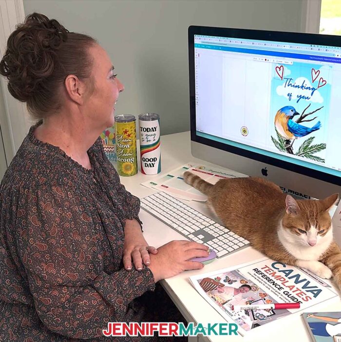 Learn How To Make Canva Templates with the free tutorial! Jennifer Maker designs a card on her computer in Canva, while her orange and white cat, Butterscotch, keeps her desk warm