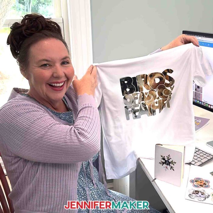 Learn How To Make A Frame In Canva! Jennifer Maker sit at her computer and holds up a T-shirt designed in Canva with a frame and a pet photo