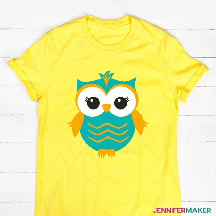Yellow t-shirt with a layered iron-on vinyl owl in blue, orange, and white HTV to show how to layer vinyl on a shirt