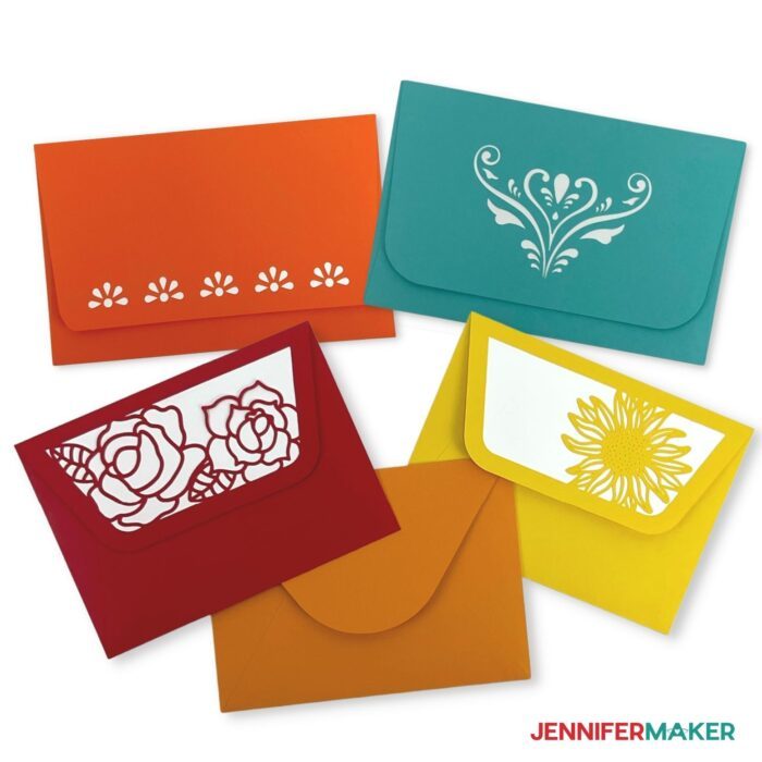 A group of handmade envelopes with decoratively cut closures from the how to make an envelope tutorial