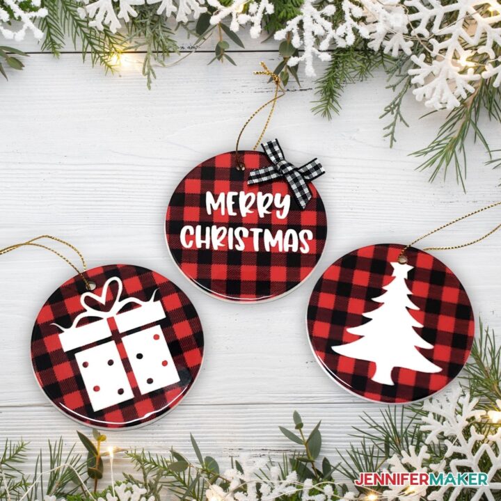 Infusible Ink Ornaments with a red and black plaid design and Christmas design in white