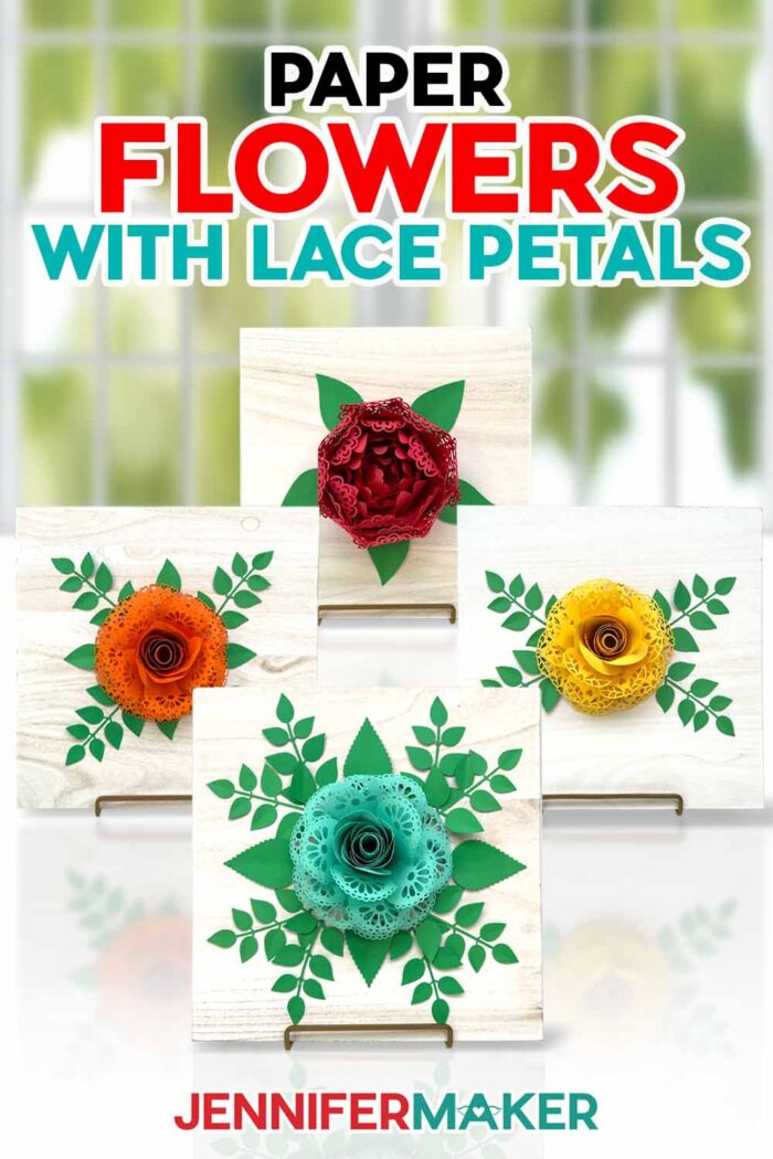 Paper Flowers with Lace Petals Tutorial by Jennifer Maker. Four paper flowers with lace petals on wood signs sit on a table.