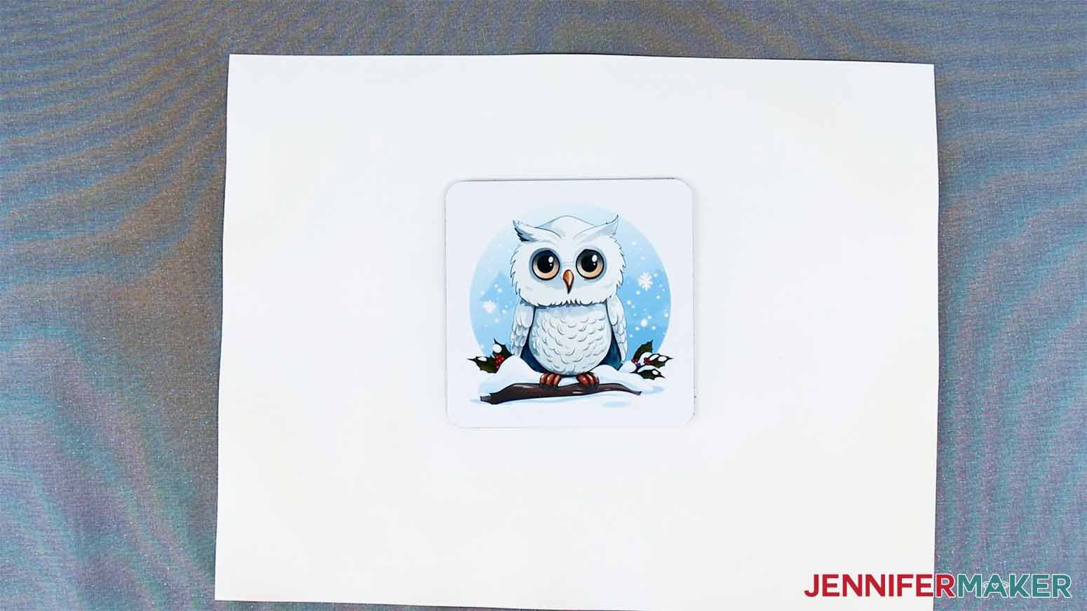 Finished sqaure Cricut coaster with winter owl sublimation design.