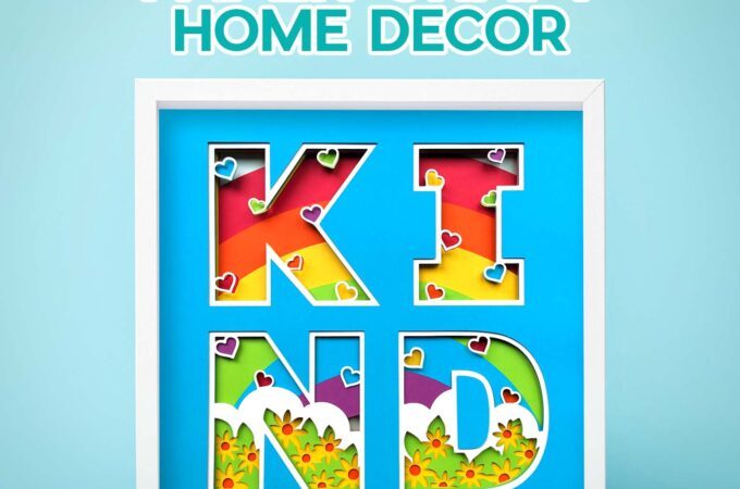 Layered KIND paper craft home decor shadow box with a rainbow background showing through the letters and butterfly and flower details designed by JenniferMaker