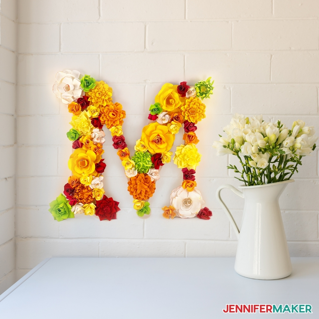 pretty paper flower letter next to flower bouquet