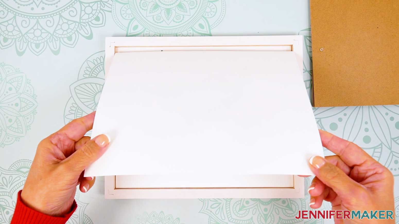 Place the pressed flower silhouette into the frame for display.