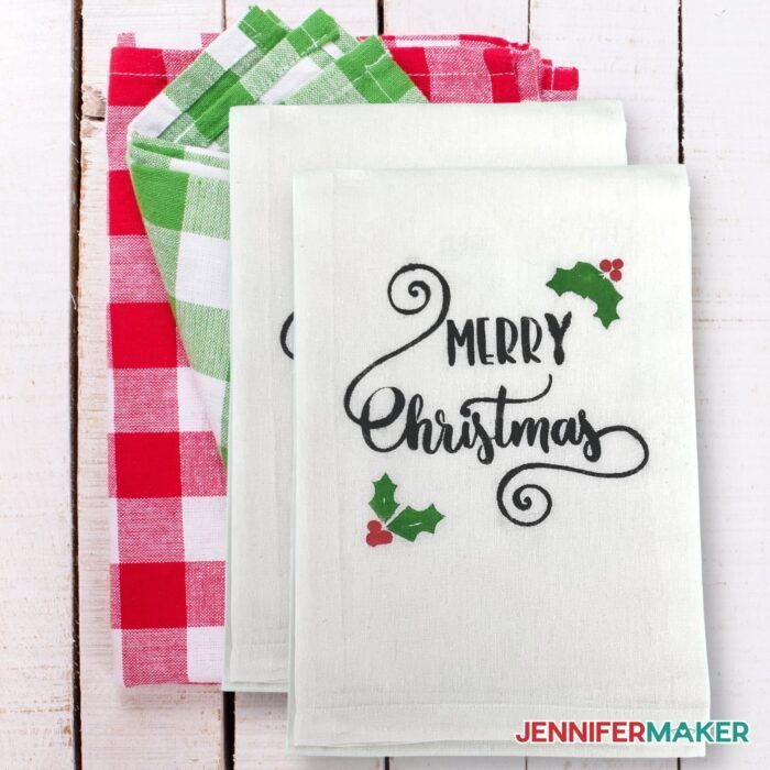 Towel with the words "Merry Christmas" on it made using a reusable stencil with Cricut cutting machine