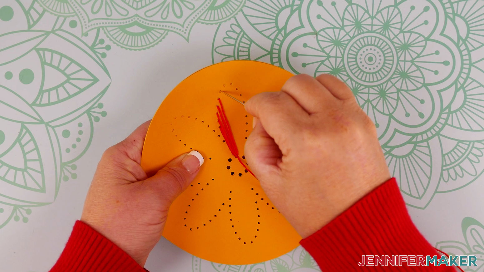 string art patterns flower design being threaded with orange embroidery thread