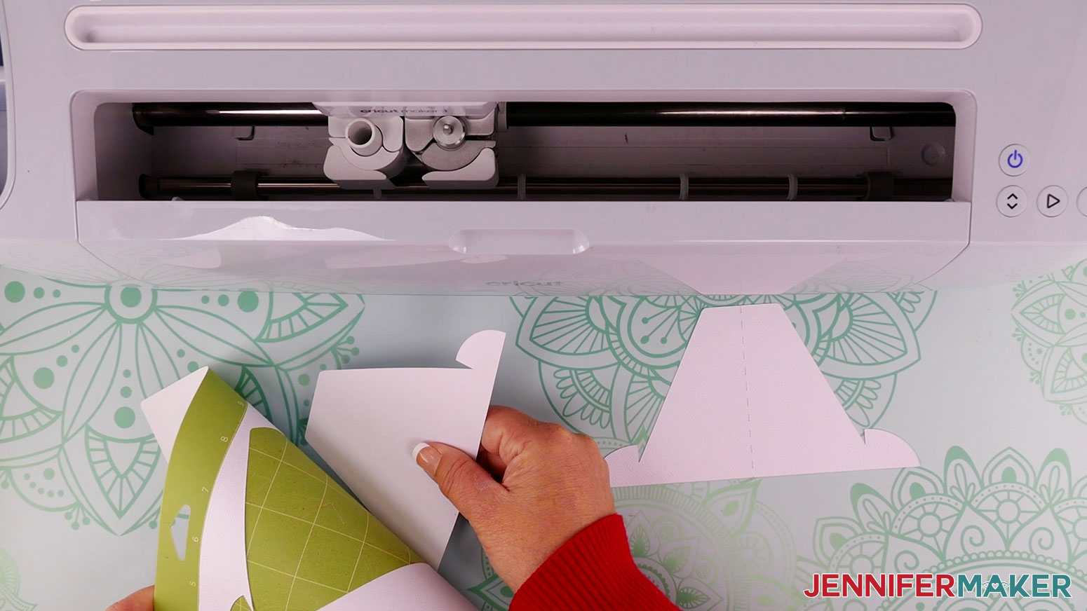 string art patterns stand out of white cardstock being removed from a green standard grip Cricut machine mat