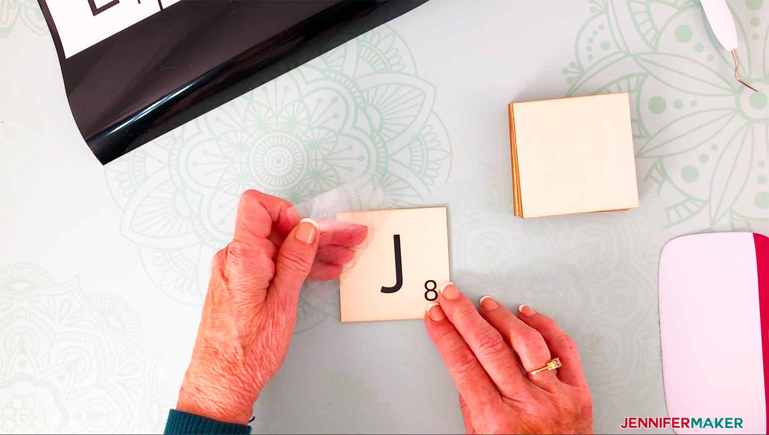 remove the transfer tape from the tile for my scrabble wall art