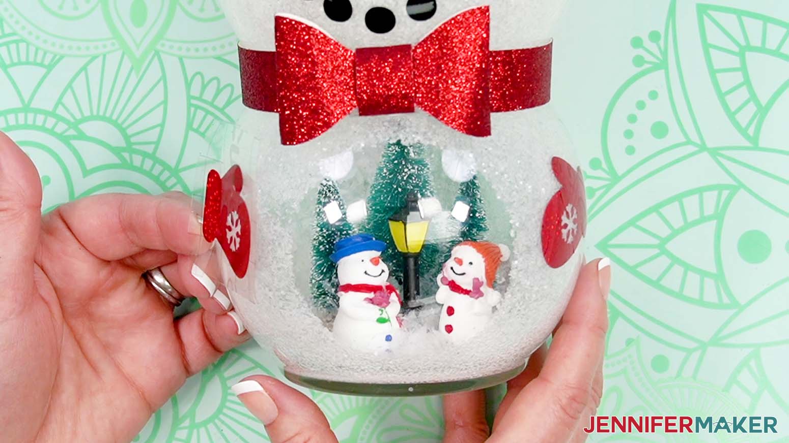 Align and place the mittens on the side of the snowman belly to the sides of the scene.
