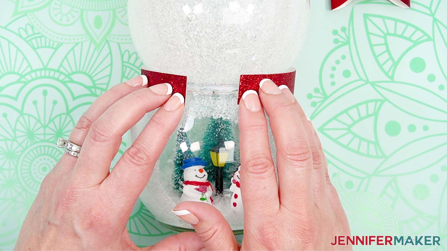 Wrap the bowtie neck piece around the snowman leaving a gap in the front.