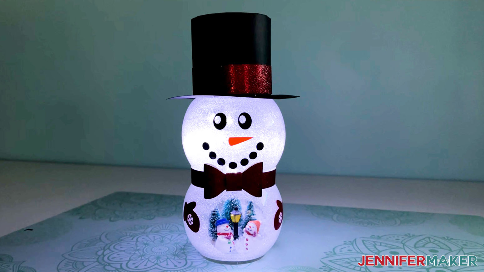 Complete snowman with belly scene lit for display.