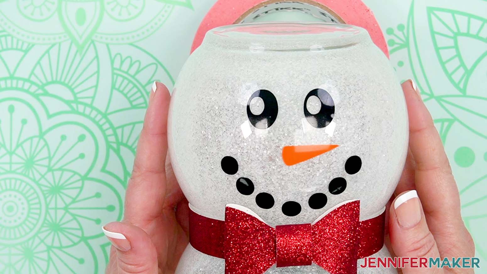Remove the transfer tape to reveal the placed vinyl face on the glass snowman.