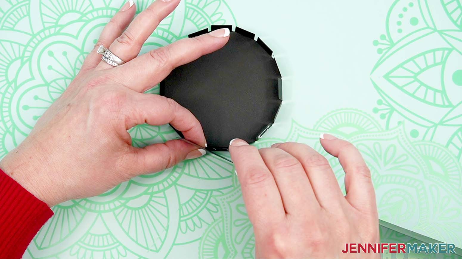 Begin attaching the side of the hat to the glued top tabs.