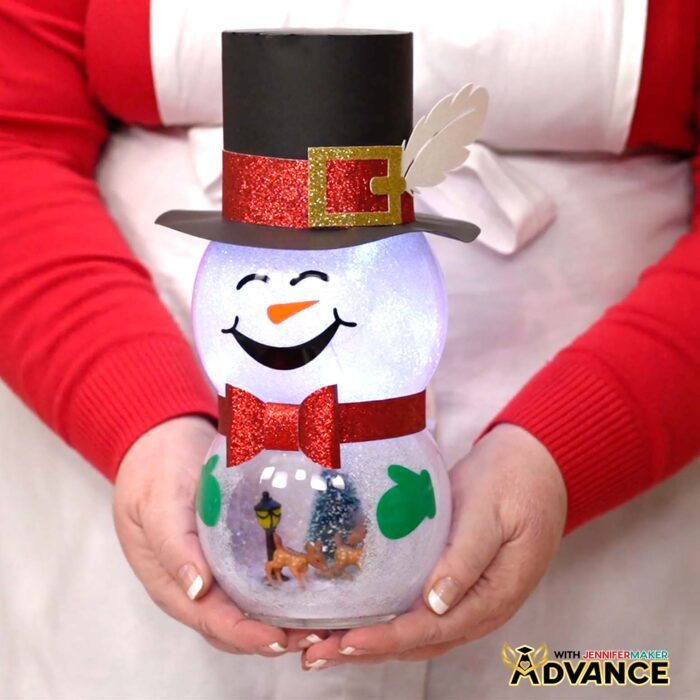 Jennifer holds a cute Snowman With Belly Scene of a deer inside