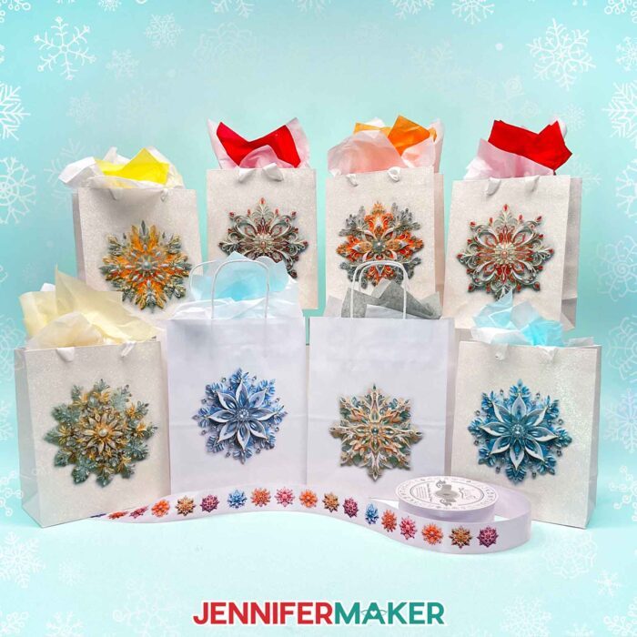 Make DIY Sublimation Gift Supplies with JenniferMaker's tutorial! A roll of ribbon and eight gift bags stuffed with colorful tissue paper feature intricate sublimated snowflake designs.