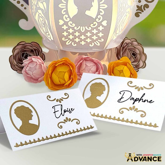Two name place cards, perfect for your next tea party! Each card has a gold silhouette of a woman with fleur-de-lis inspired details and a name written on it.