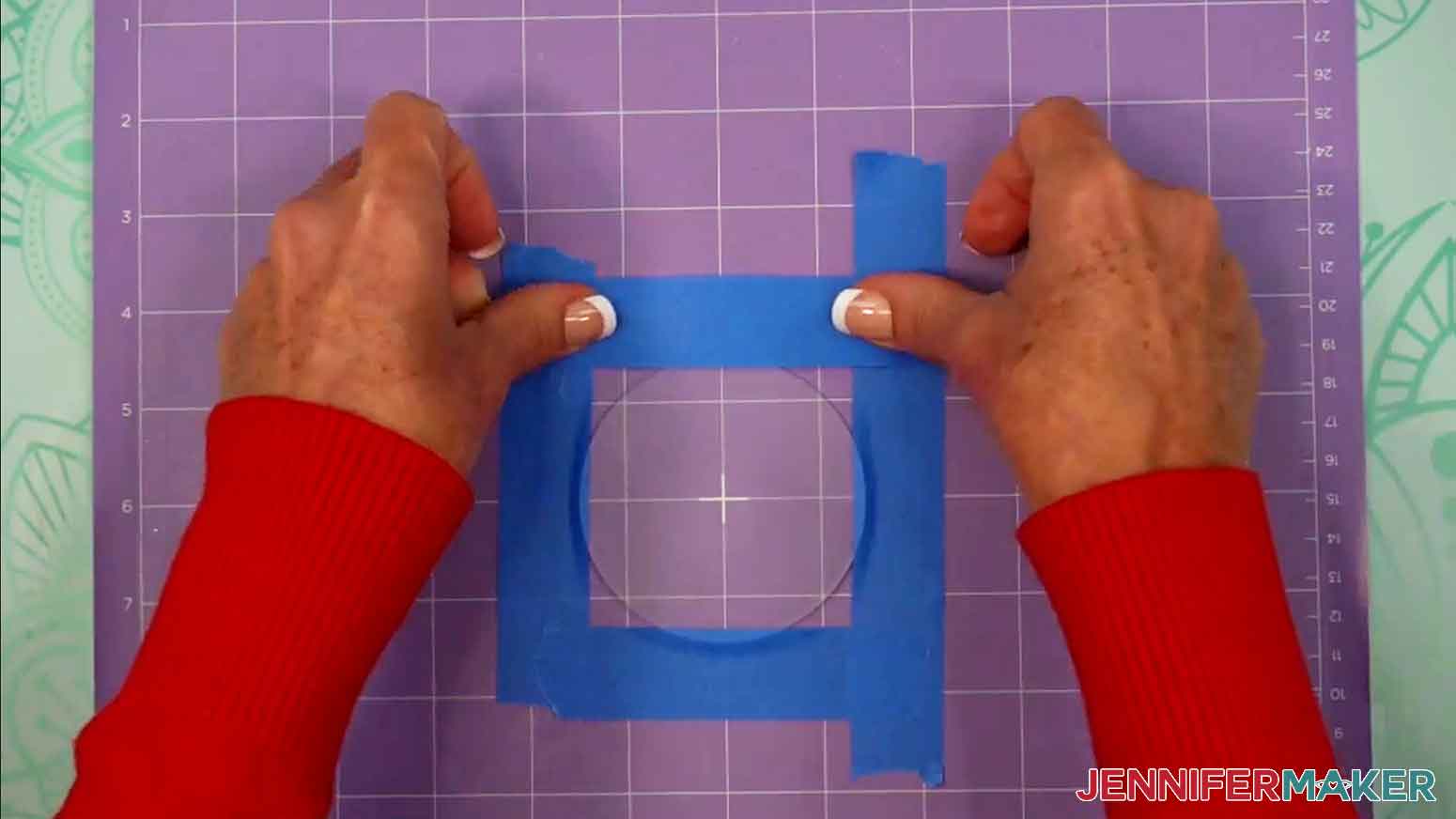 Painters tape is being used on the edges of the orament and the top piece to hold it down while engraving.