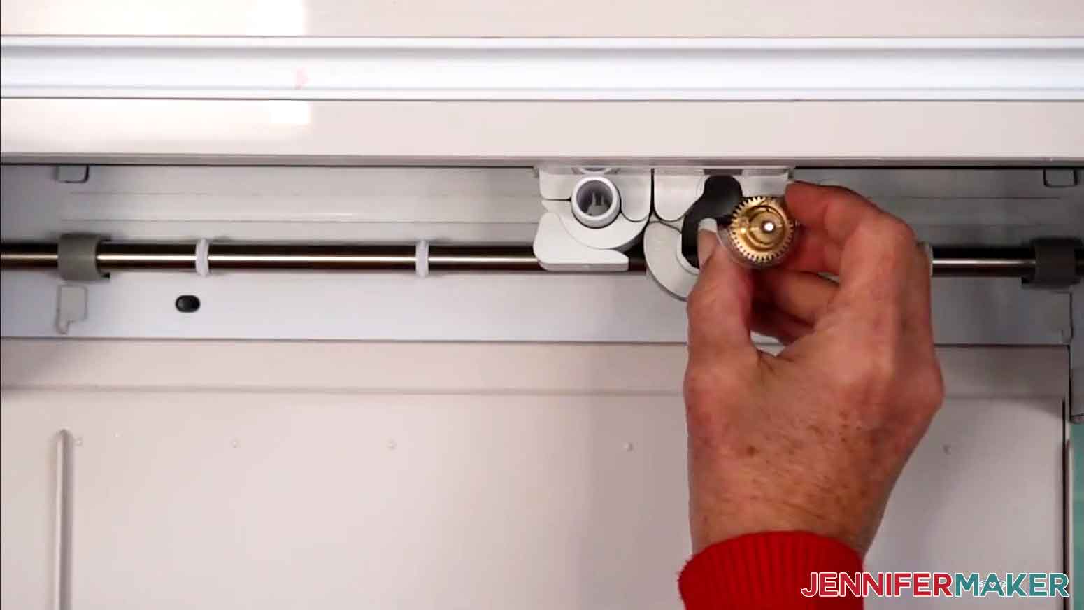 The Cricut is open and the engraving tool is being inserted into the B tool slot.