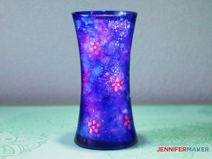 alcohol ink on glass to design a blue glass vase with pink flowers