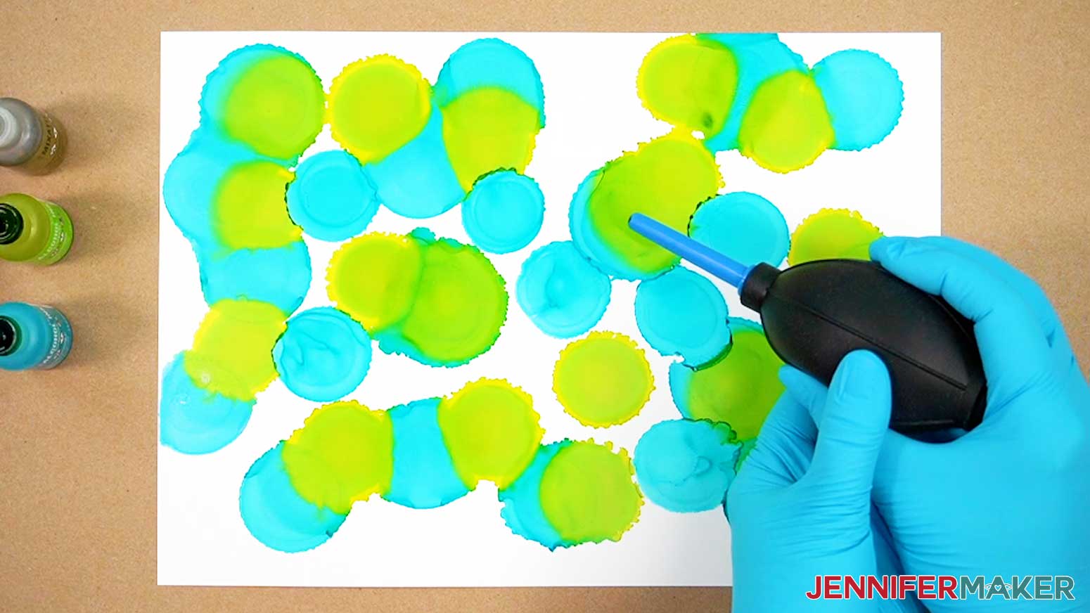Use a blower tool to push the wet alcohol inks around on the paper.