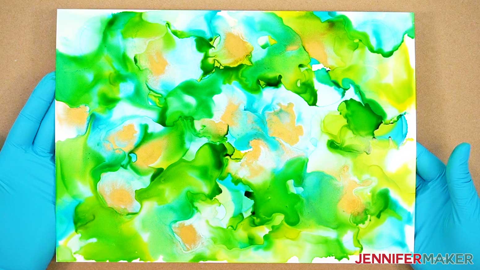 The dry alcohol ink paper with several colors of ink blended together on it.