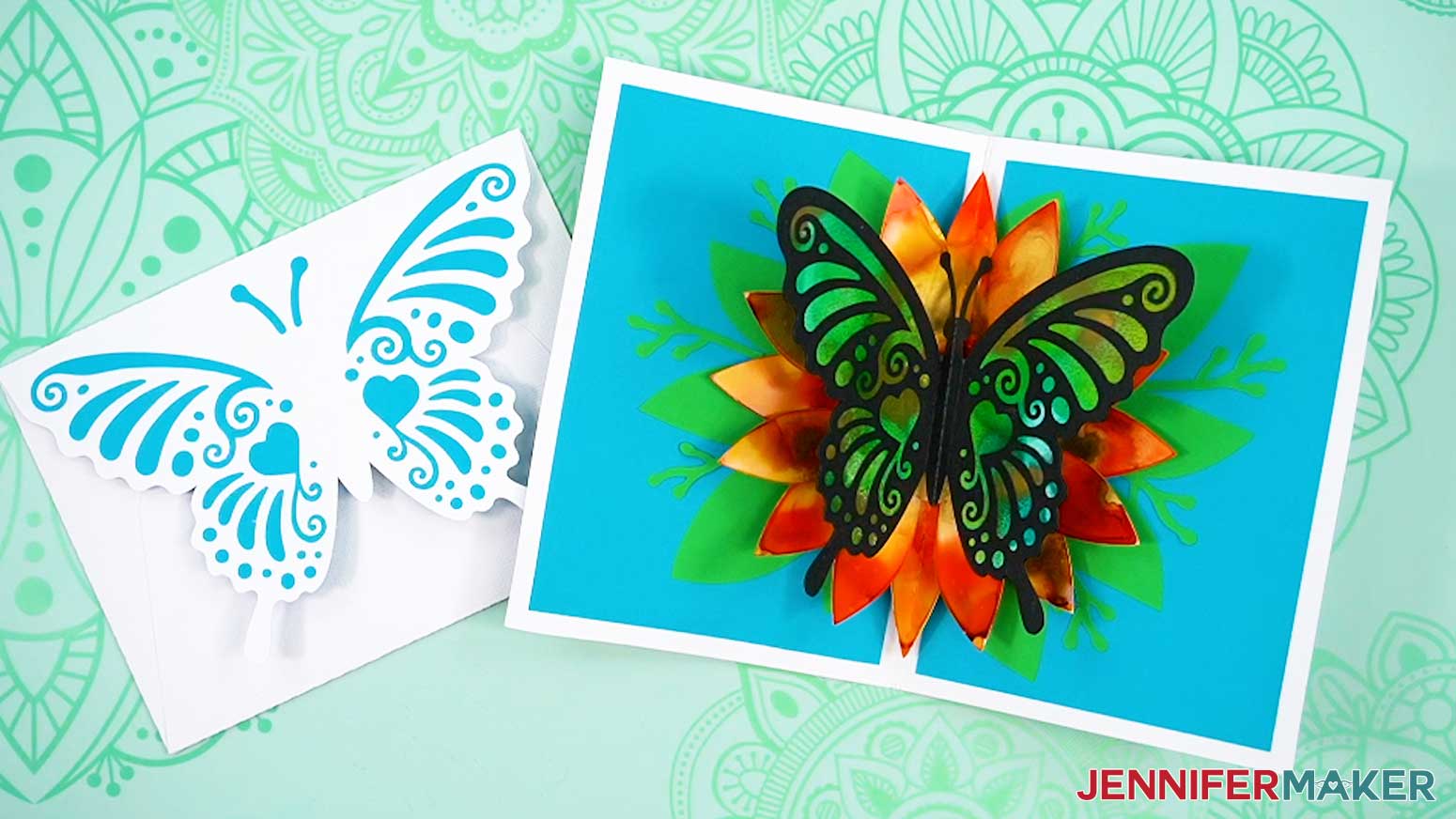 A finished butterfly pop up card and envelope, with alcohol ink on the butterfly's wings and flower petals.