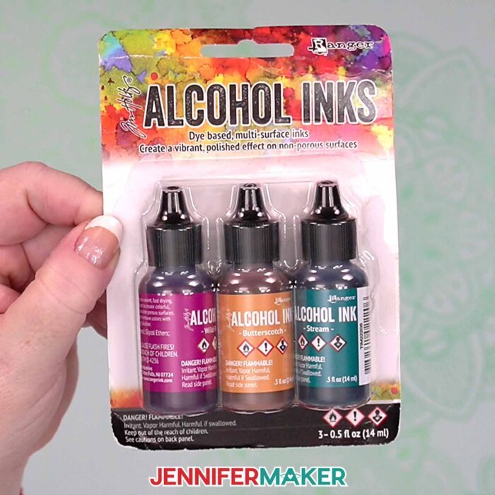 Pack of three alcohol inks bottles from Tim Holtz Ranger brand, used to paint Alcohol Ink On Paper in the tutorial