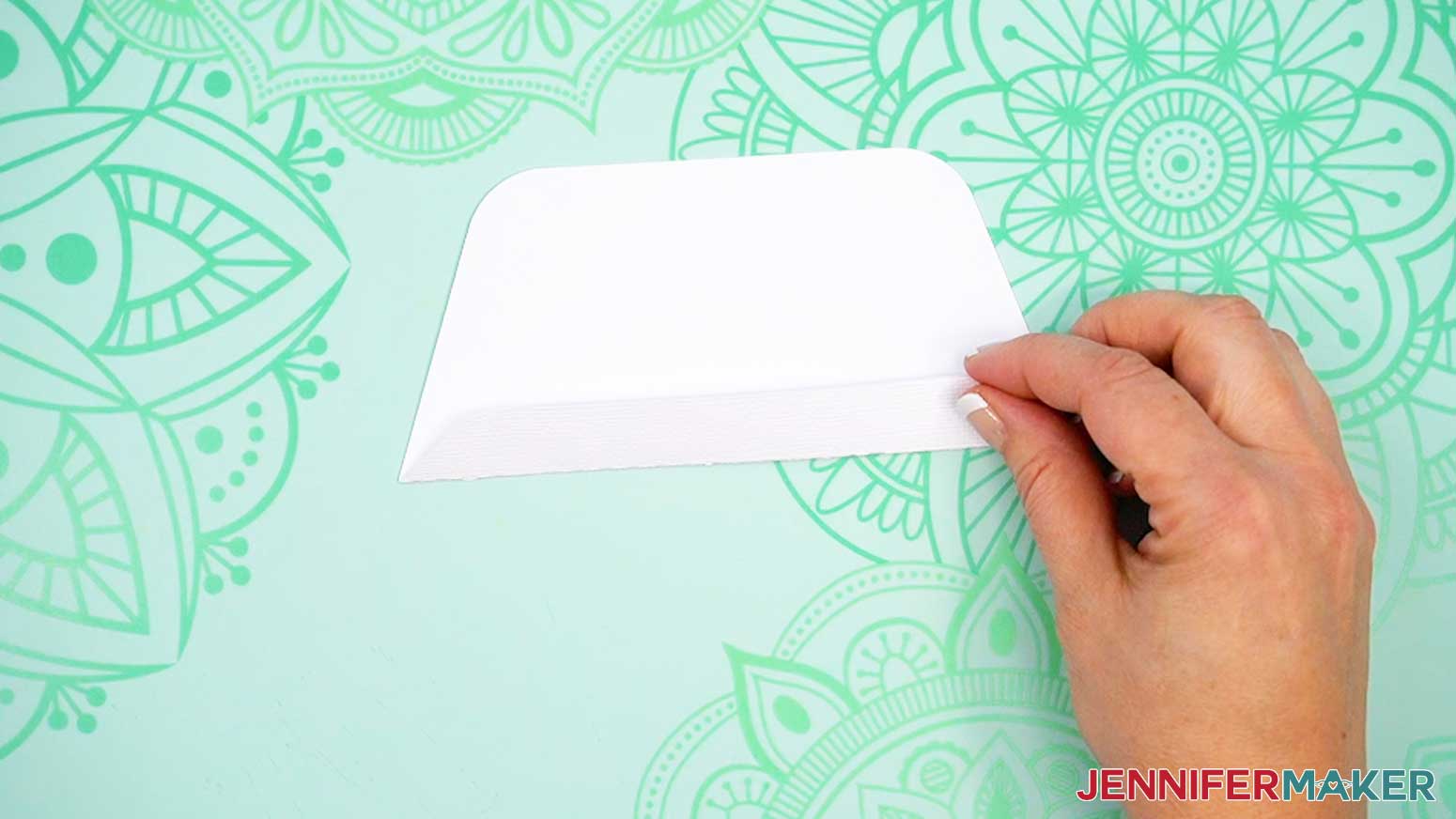 Fold the tab of the Joy-sized envelope's flap upward along the crease.