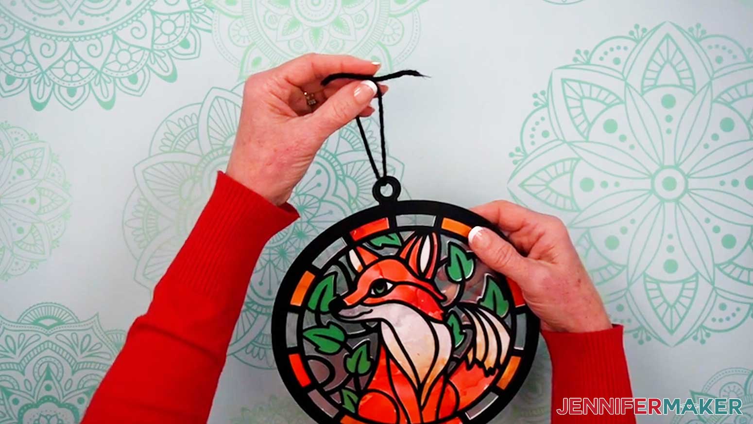 Tie a knot in the end of the yarn looped through the hanger of the Alcohol Ink Stained Glass design.