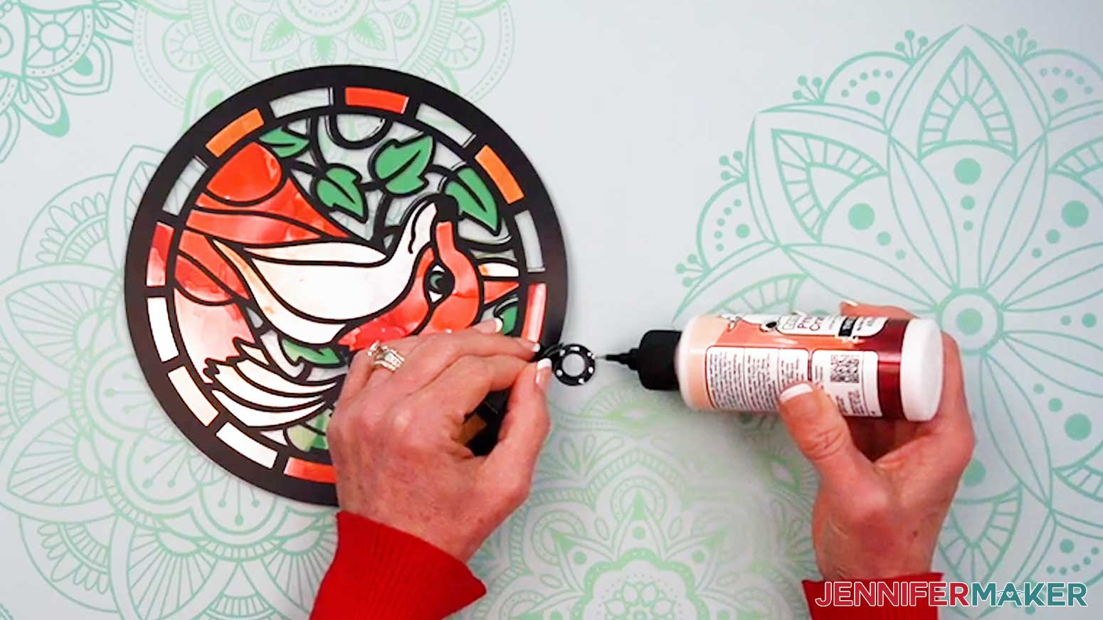Add glue to the inside of one hanger piece of the Alcohol Ink Stained Glass design to adhere it to the other.