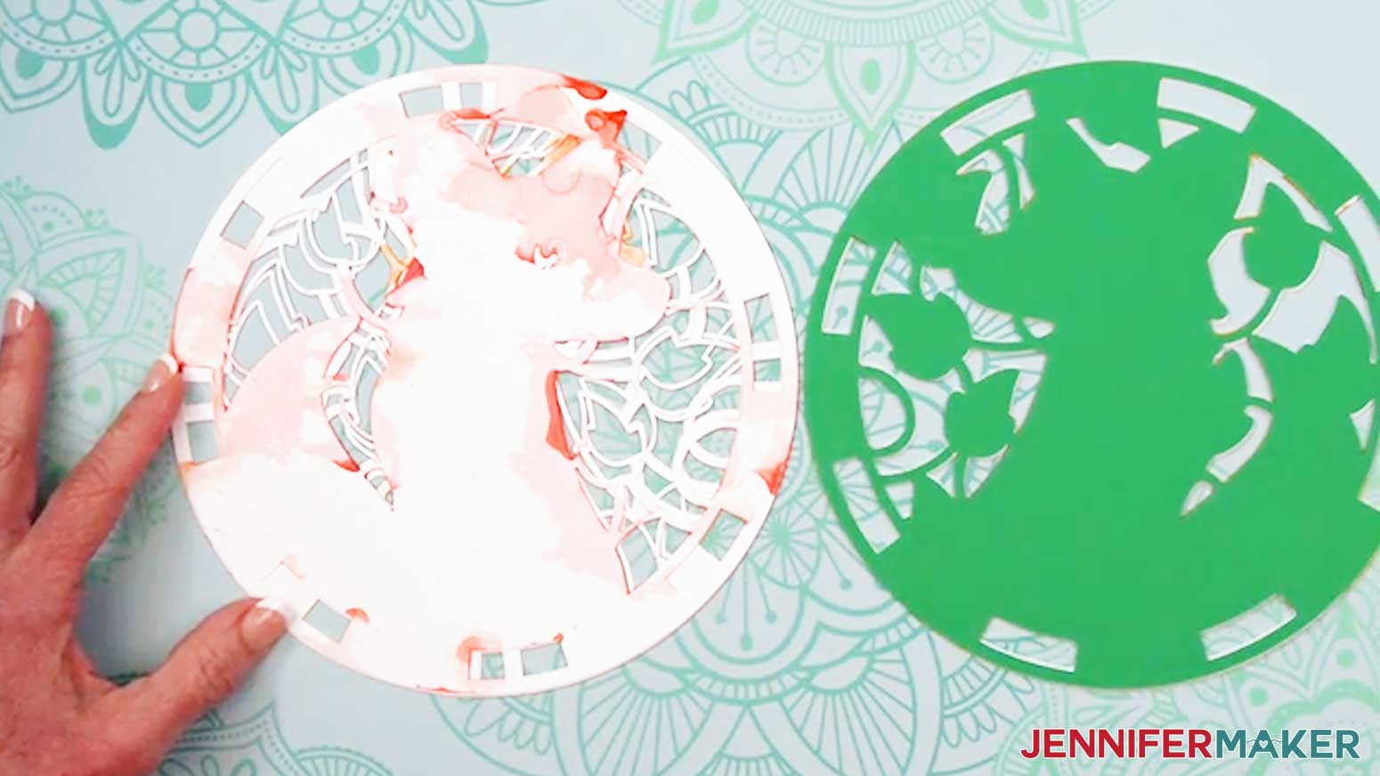 Add glue to the back of the next layer up from the center layer of the Alcohol Ink Stained Glass design.
